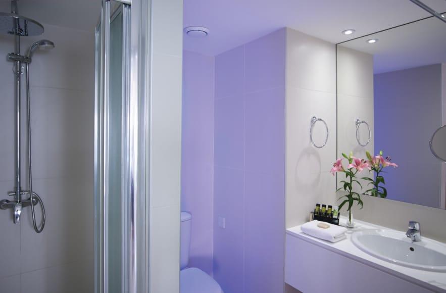 a bathroom with a sink and a shower unit