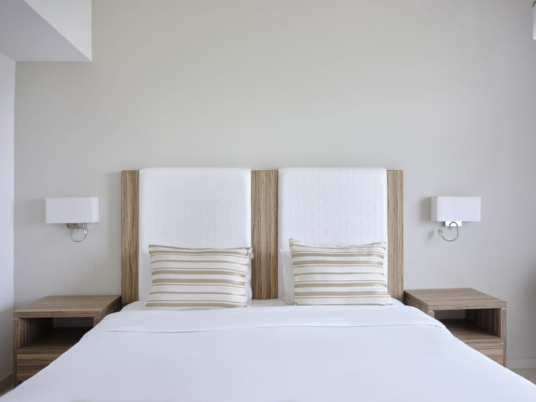 a bed with a white bed spread