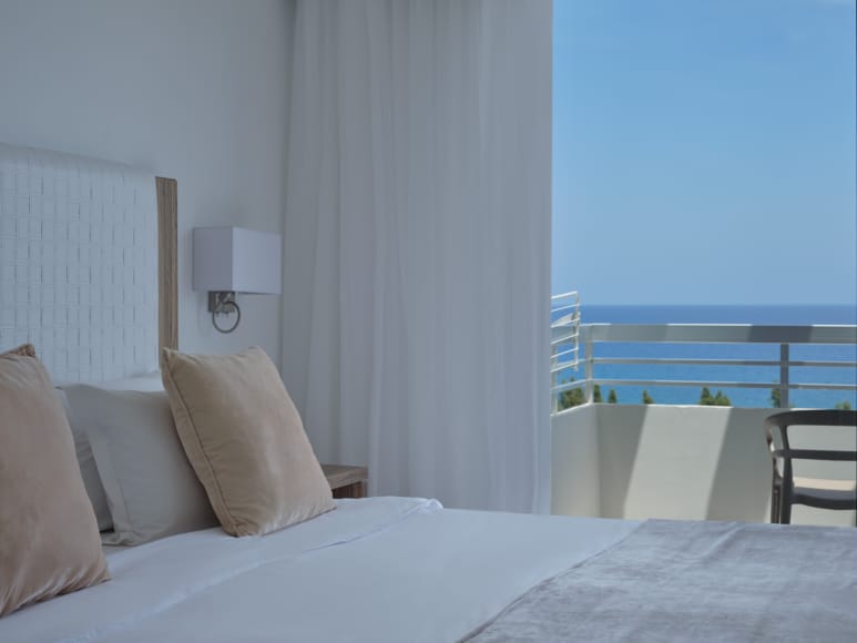 a bed with pillows and a lamp