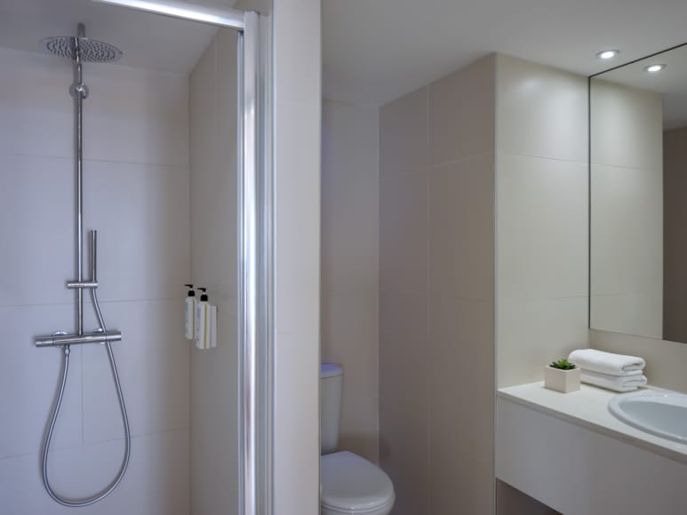 a bathroom with a shower unit and toilet