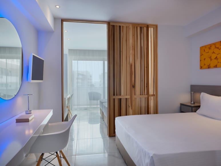 a bathroom with a bed and a mirror