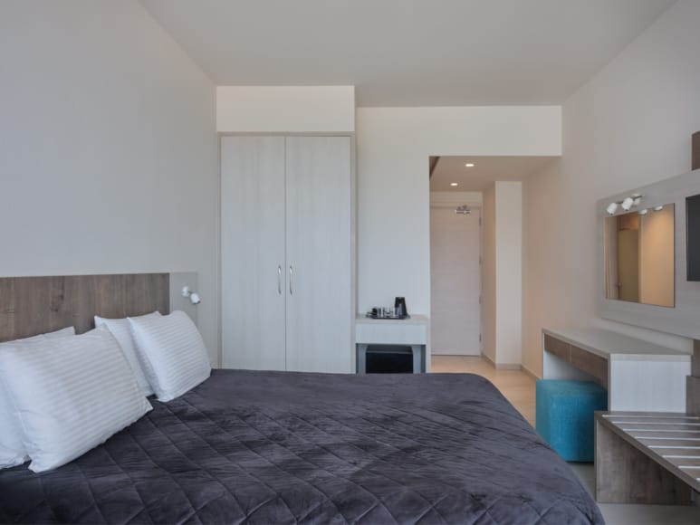 a bedroom with a bed and a mirror
