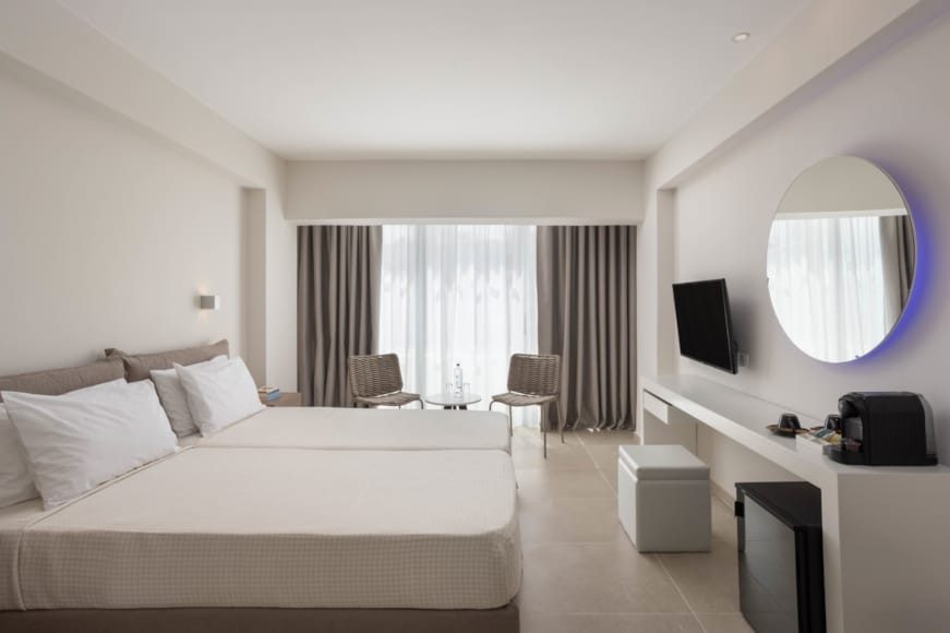 a hotel room with a bed and a tv