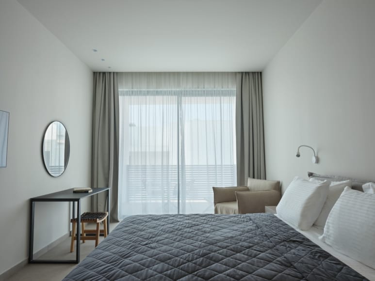 a bedroom with a bed and a mirror