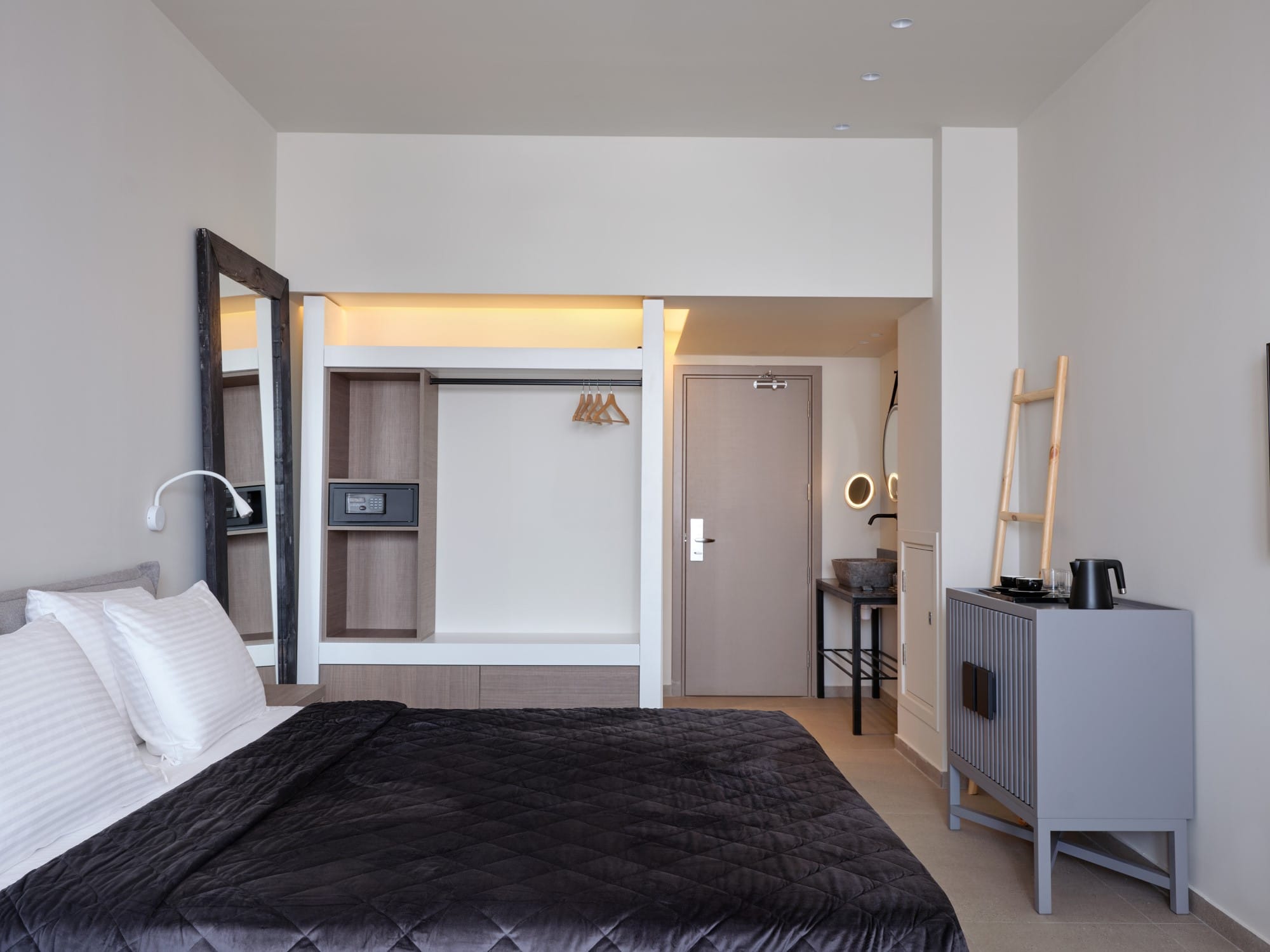 a bedroom with a mirror and a bed