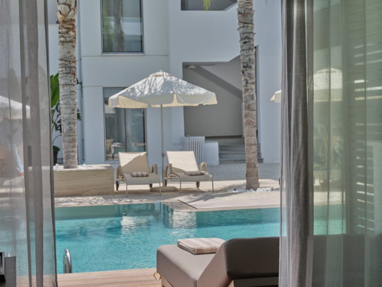 a pool with a lounge chair and umbrella