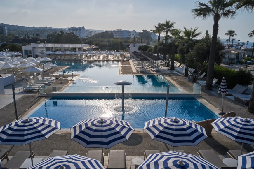 a pool with lounge chairs around it