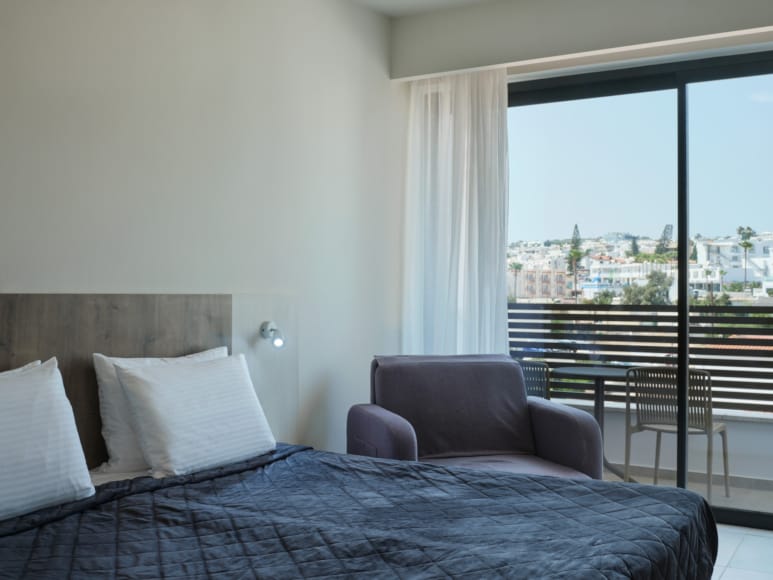 a bedroom with a large window
