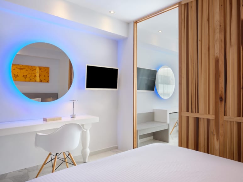 a bathroom with a bed and a tv
