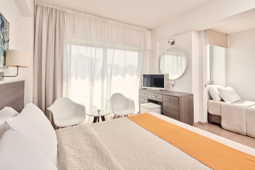 a bedroom with a bed and a tv