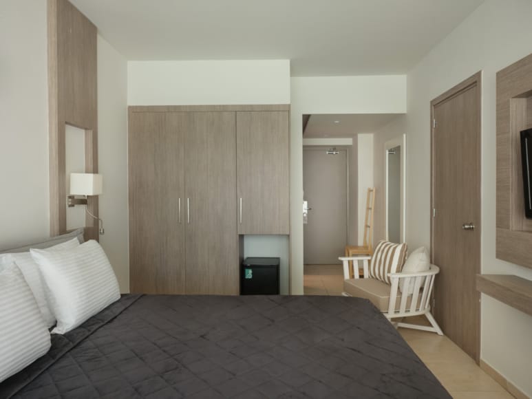 a bedroom with a bed and a chair