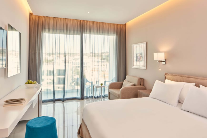 a bedroom with a bed and a chair