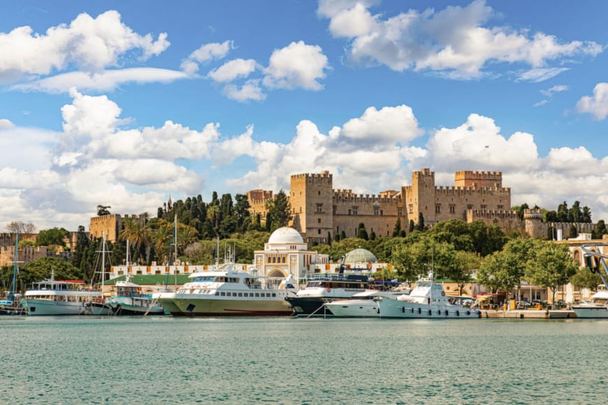 a body of water with boats and buildings in the background