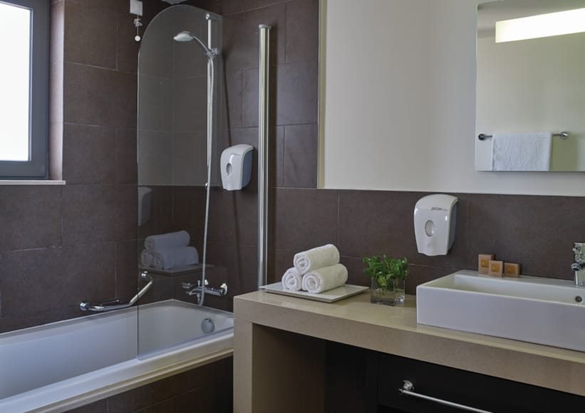 a bathroom with a tub sink and a mirror