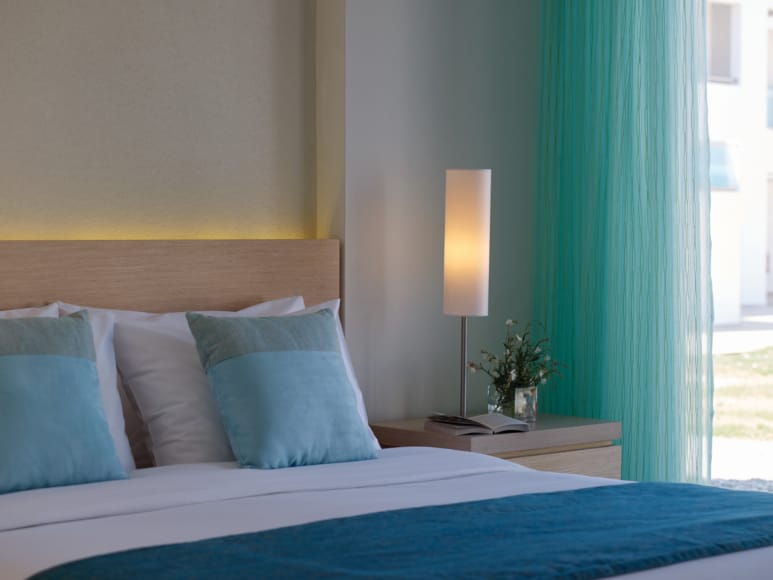 a bed with a blue comforter