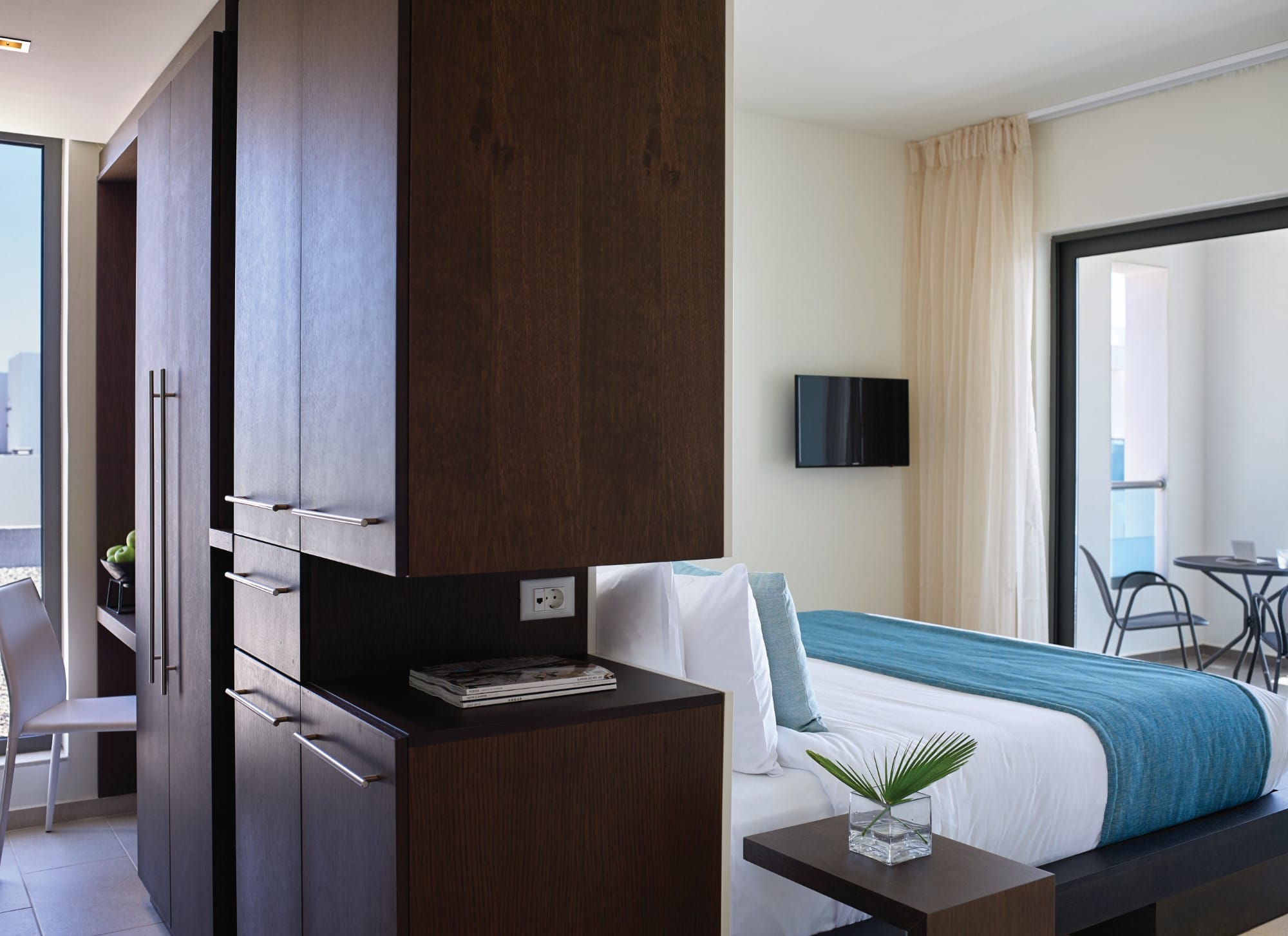 a bedroom with a bed and a tv