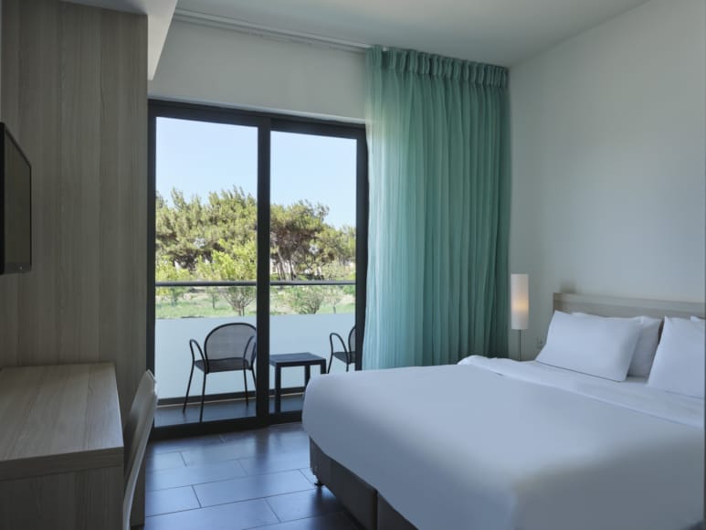 a bedroom with a large window