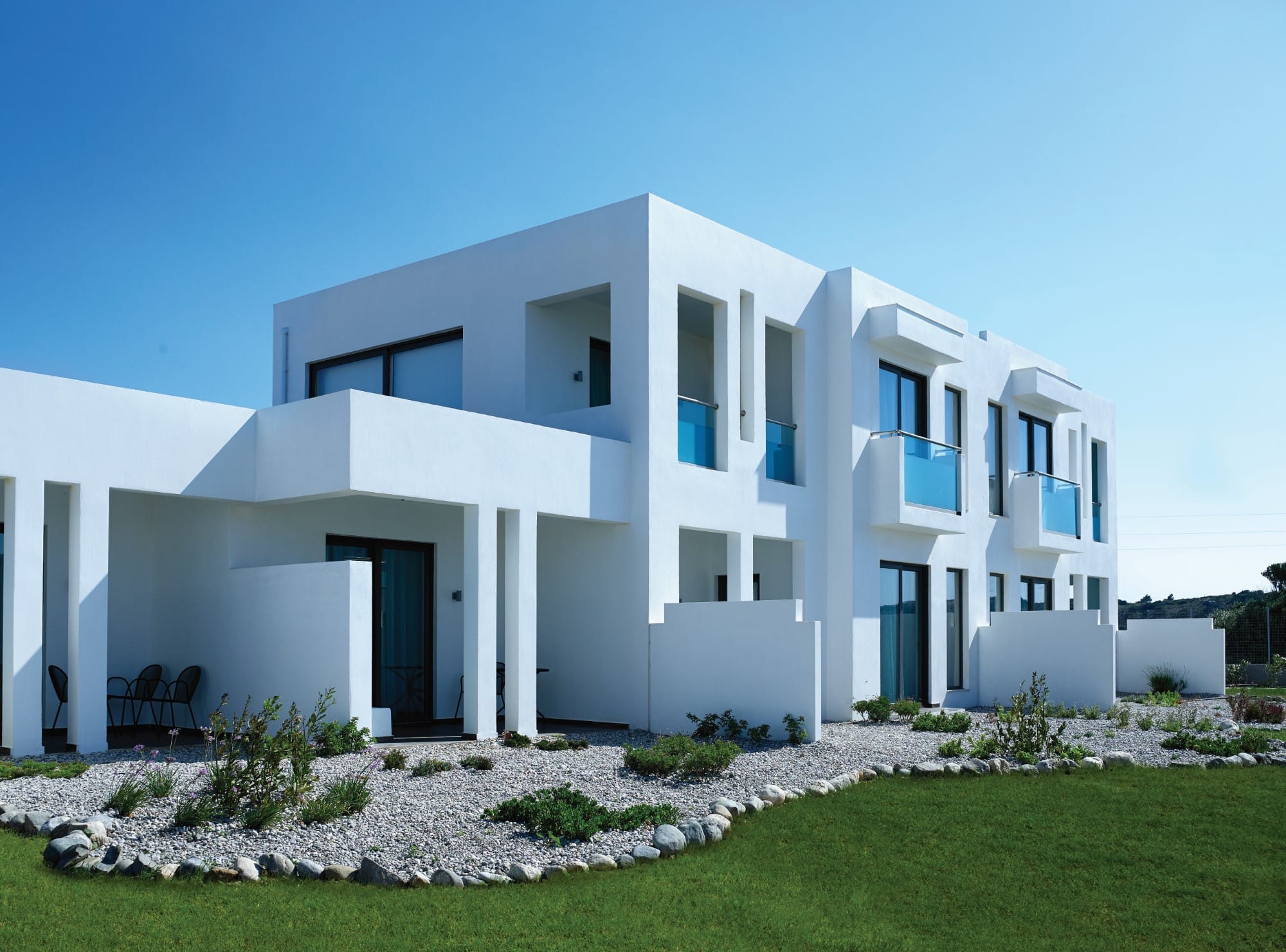 a white house with a lawn