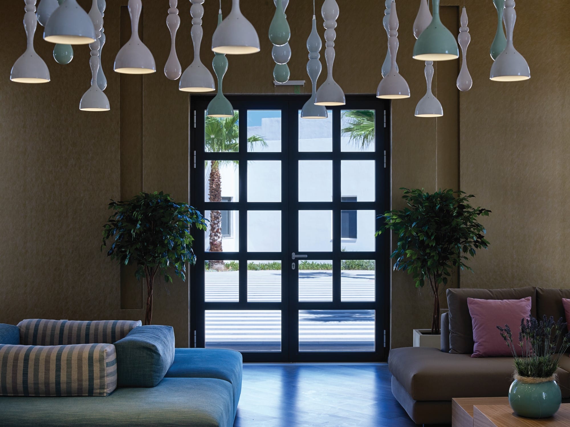 a room with a large window and a couch and a table