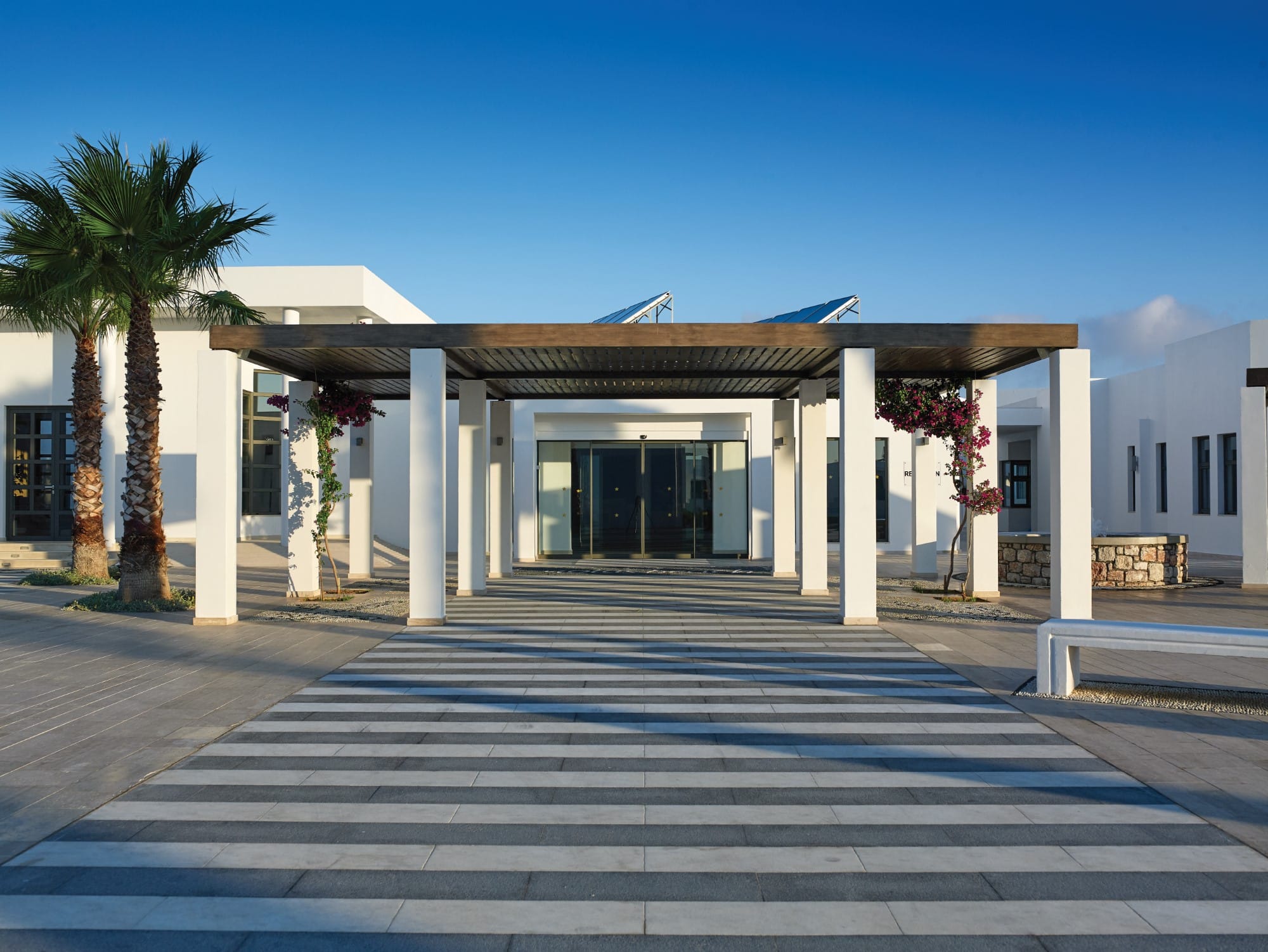 a building with columns and a parking lot