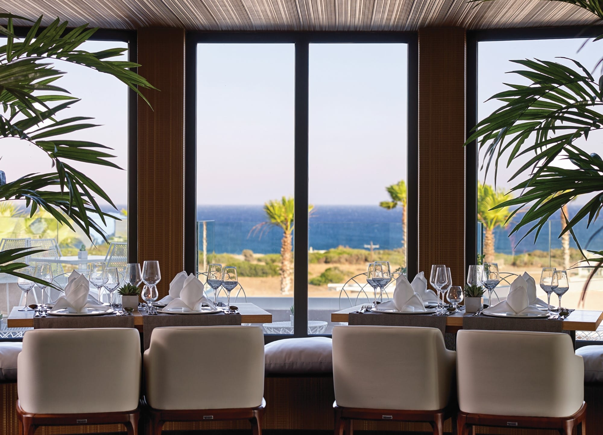 a room with a view of the ocean and trees