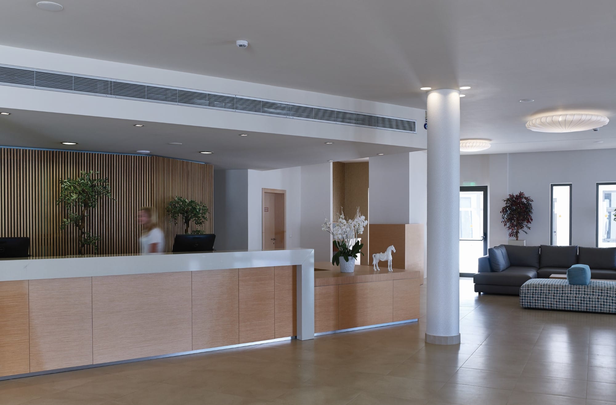 a large room with a large white pillar and a large white pillar