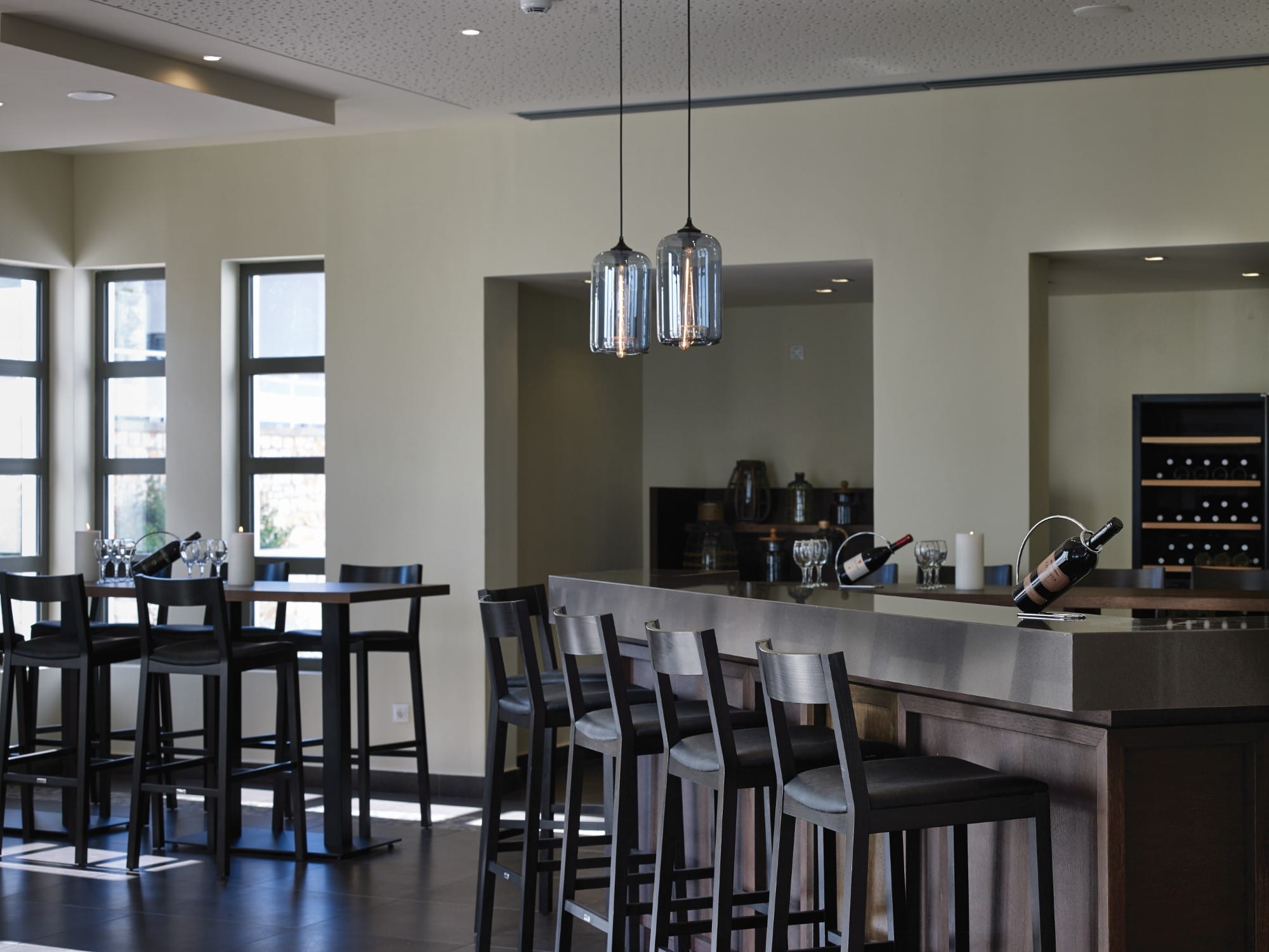 a kitchen with a bar and chairs