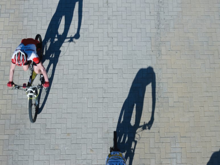 a person riding a bike on a brick wall