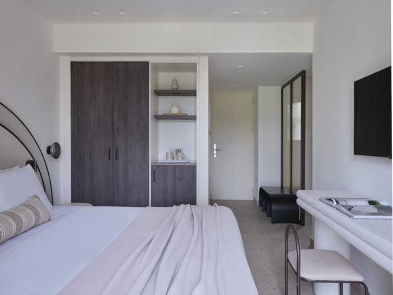 a bedroom with a bed and a desk