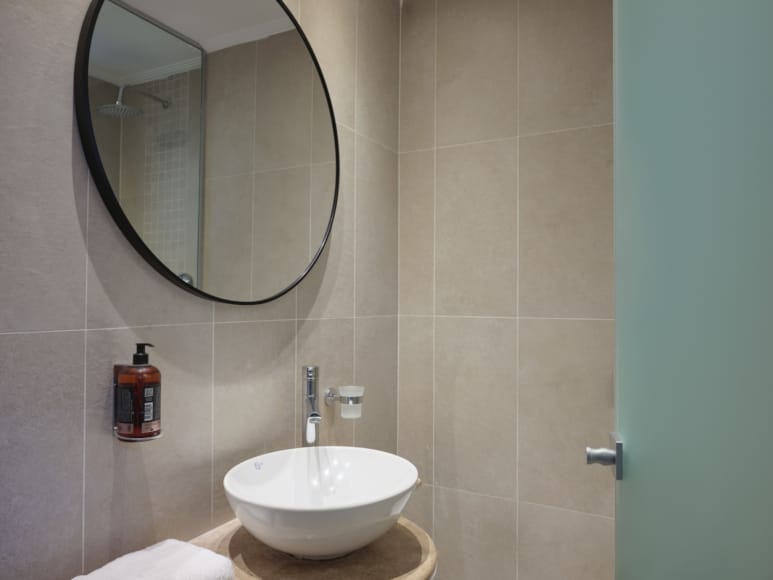 a bathroom with a round mirror