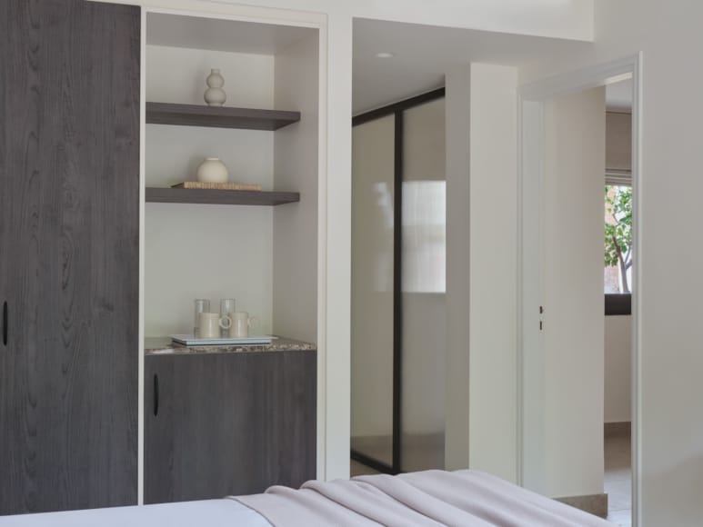 a room with a shelf and a mirror