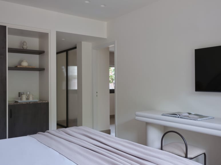 a bedroom with a bed and a tv
