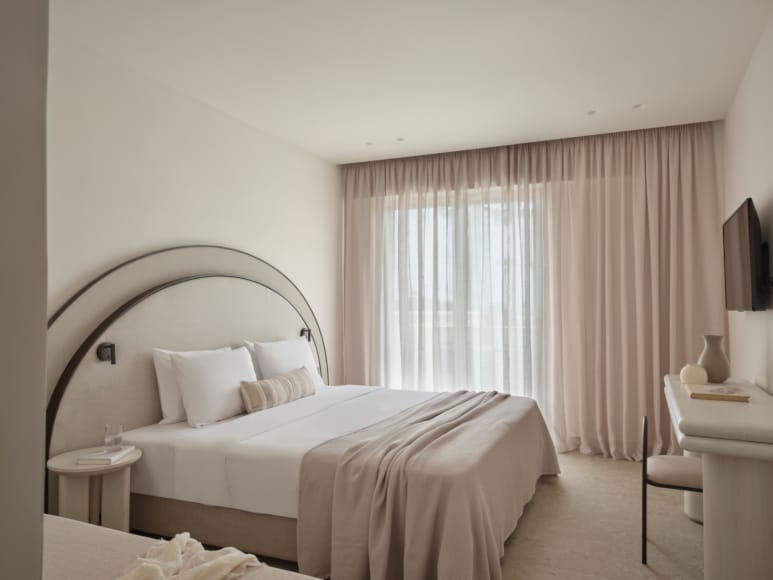 a bedroom with a bed and a chair