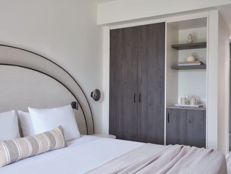 a bed with a white bed and a white shelf