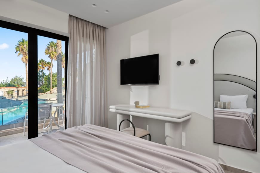 a bedroom with a large mirror