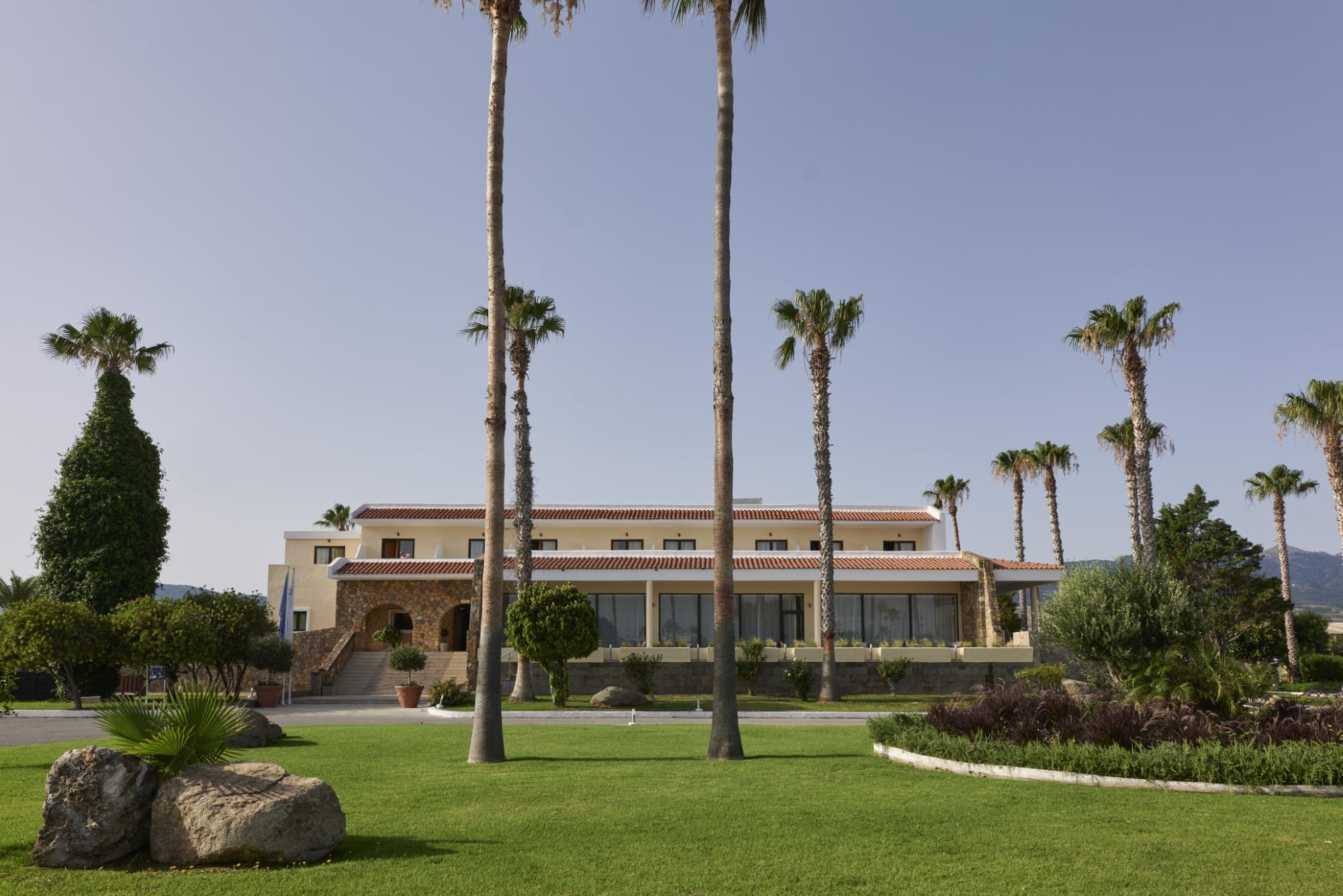 a building with palm trees in front
