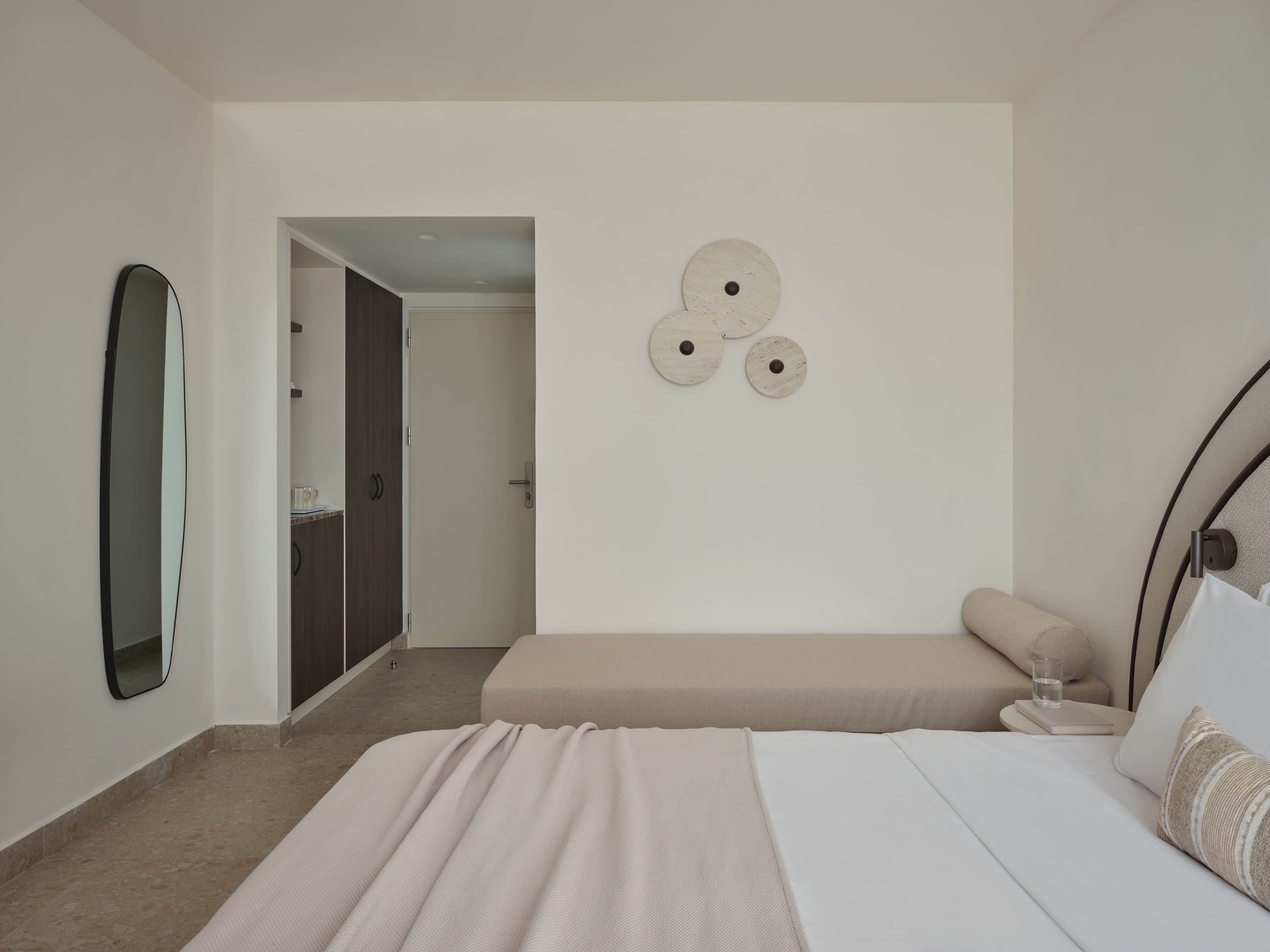 a hotel room with a bed and a mirror