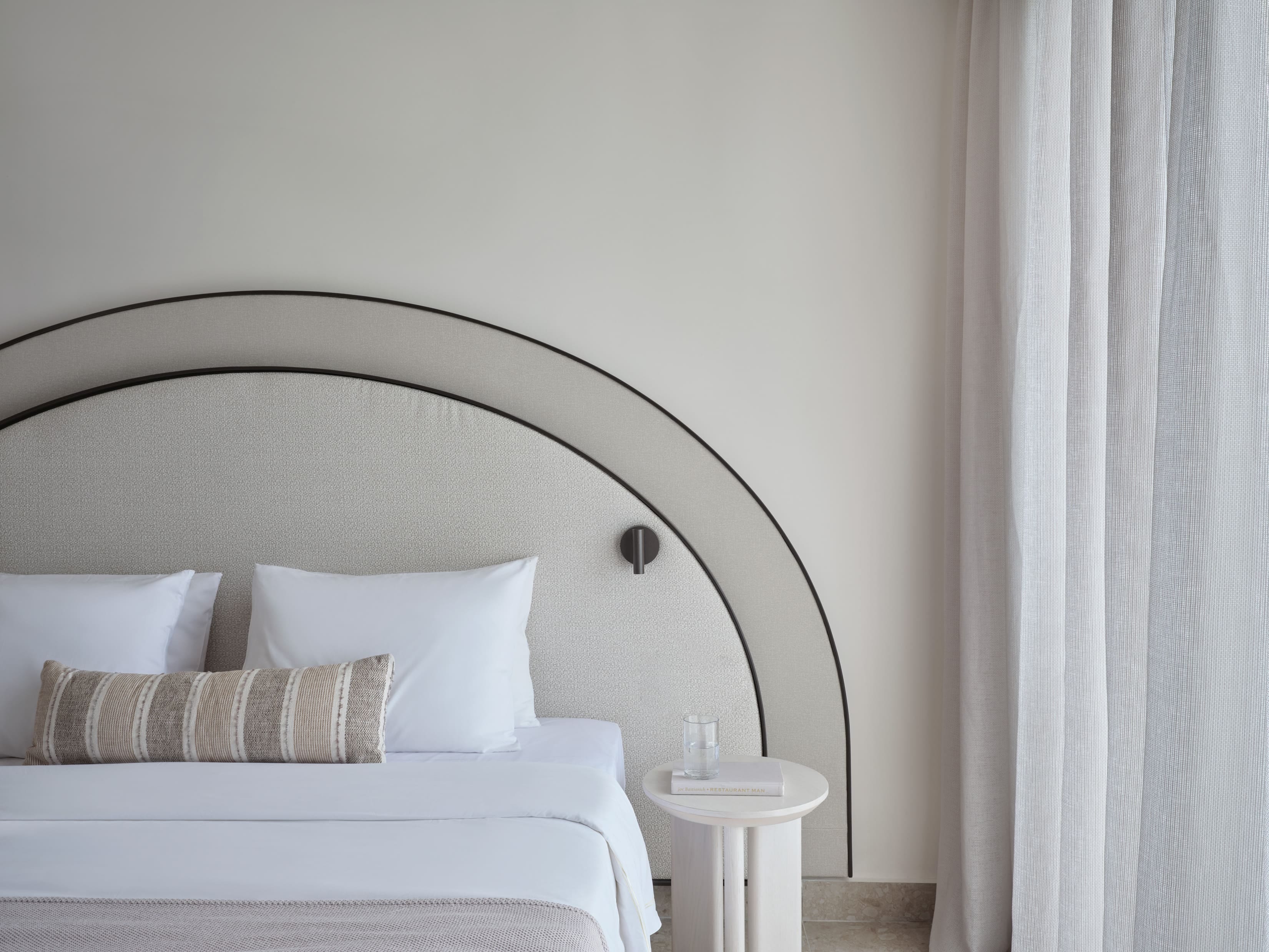 a bed with a white headboard