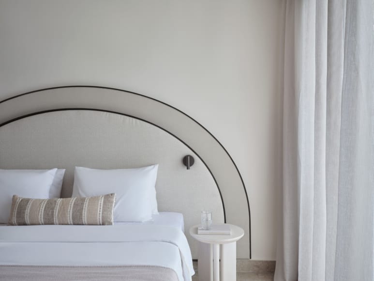 a bed with a white headboard