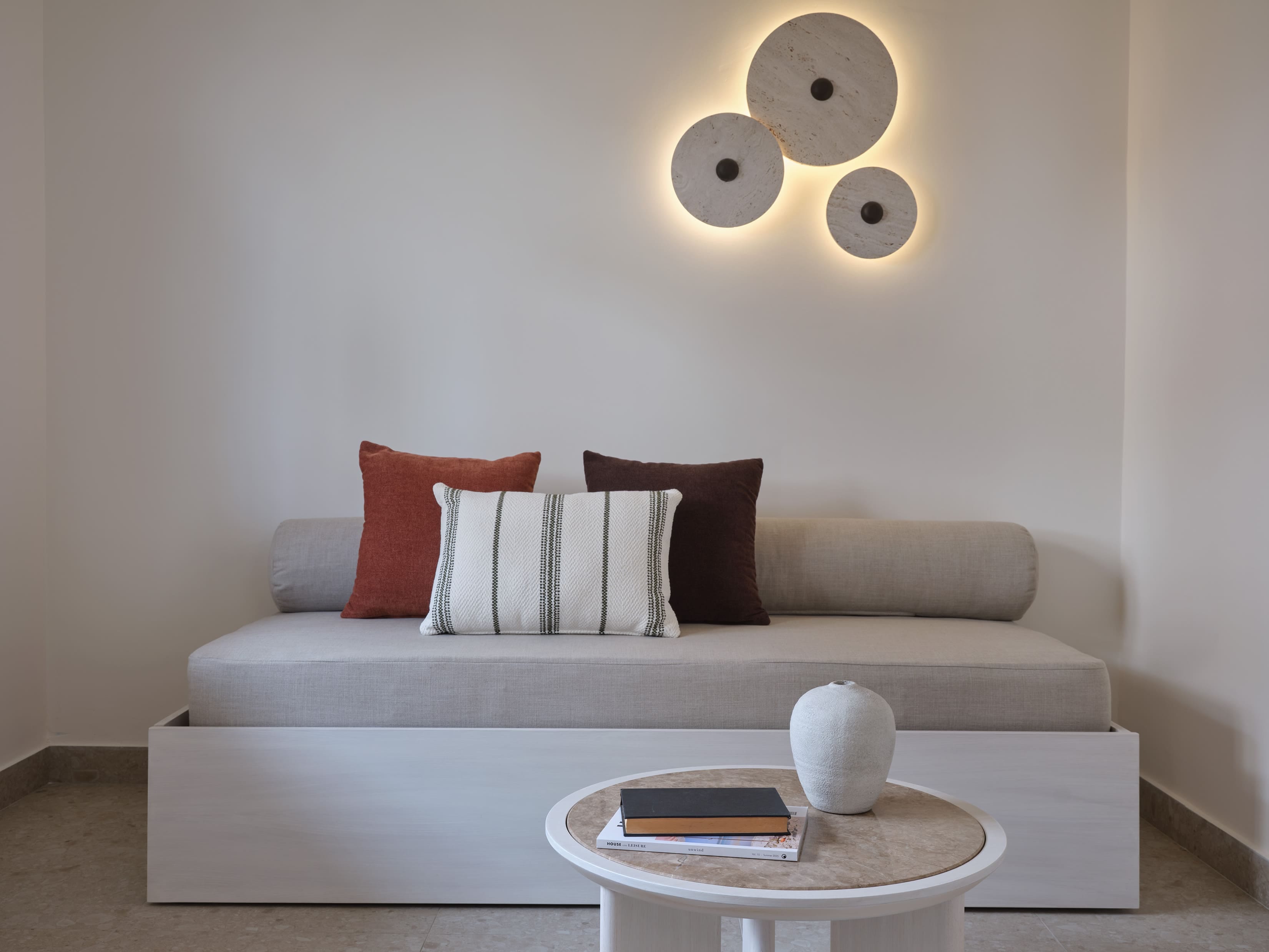 a white couch with a white coffee table and a white coffee table