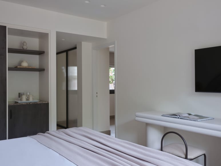 a bedroom with a bed and a tv