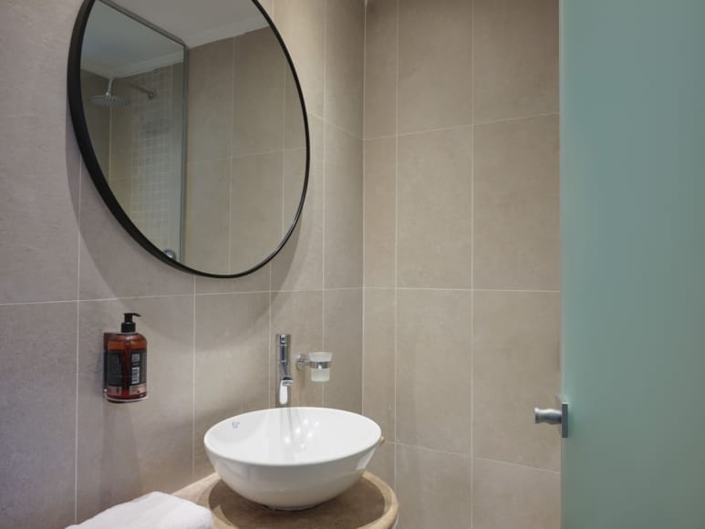 a bathroom with a round mirror