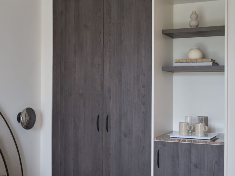 a door with a shelf and a shelf with objects on it