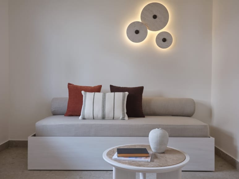 a white couch with a white coffee table and a white coffee table