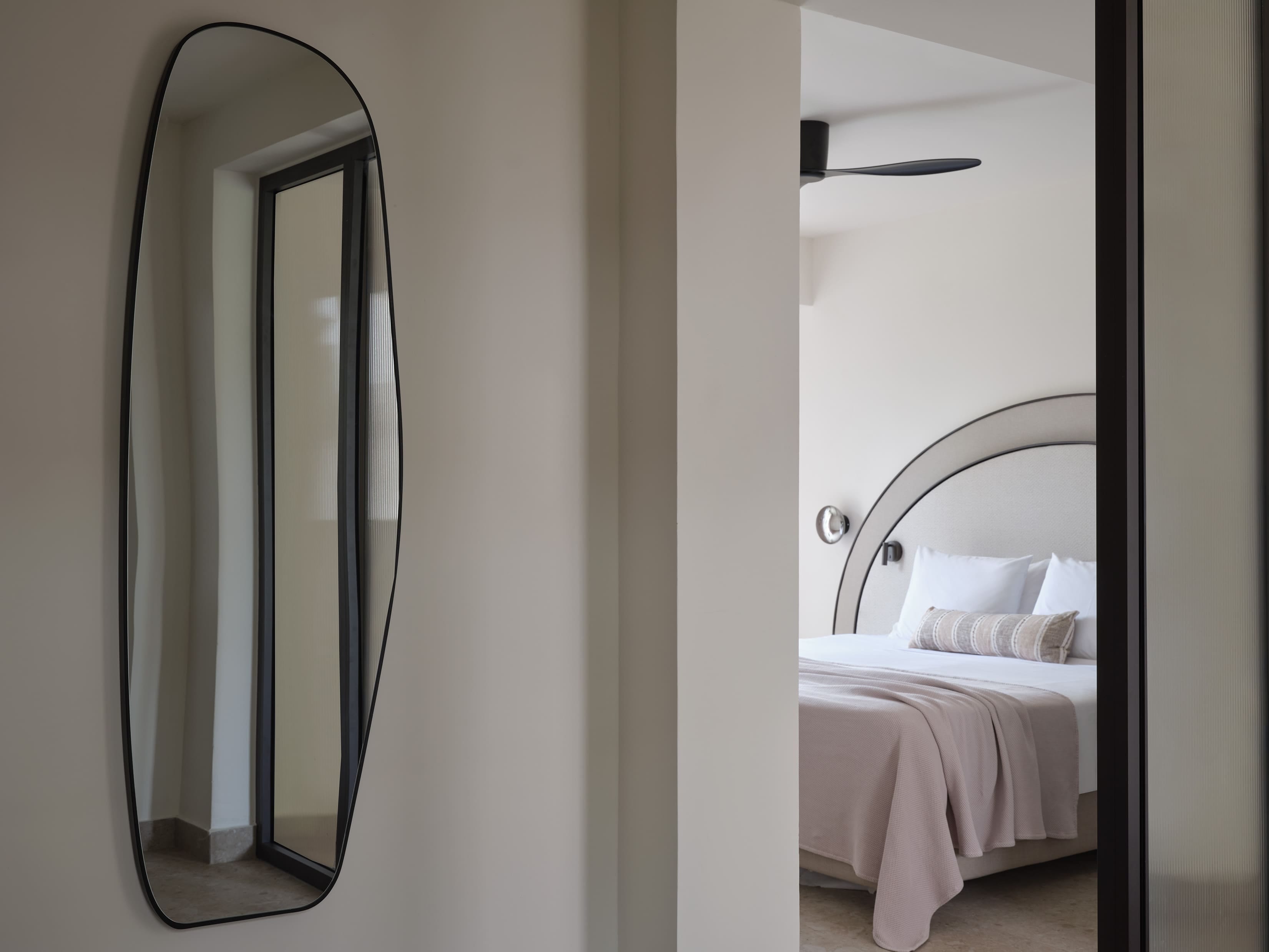a mirror is above a bed