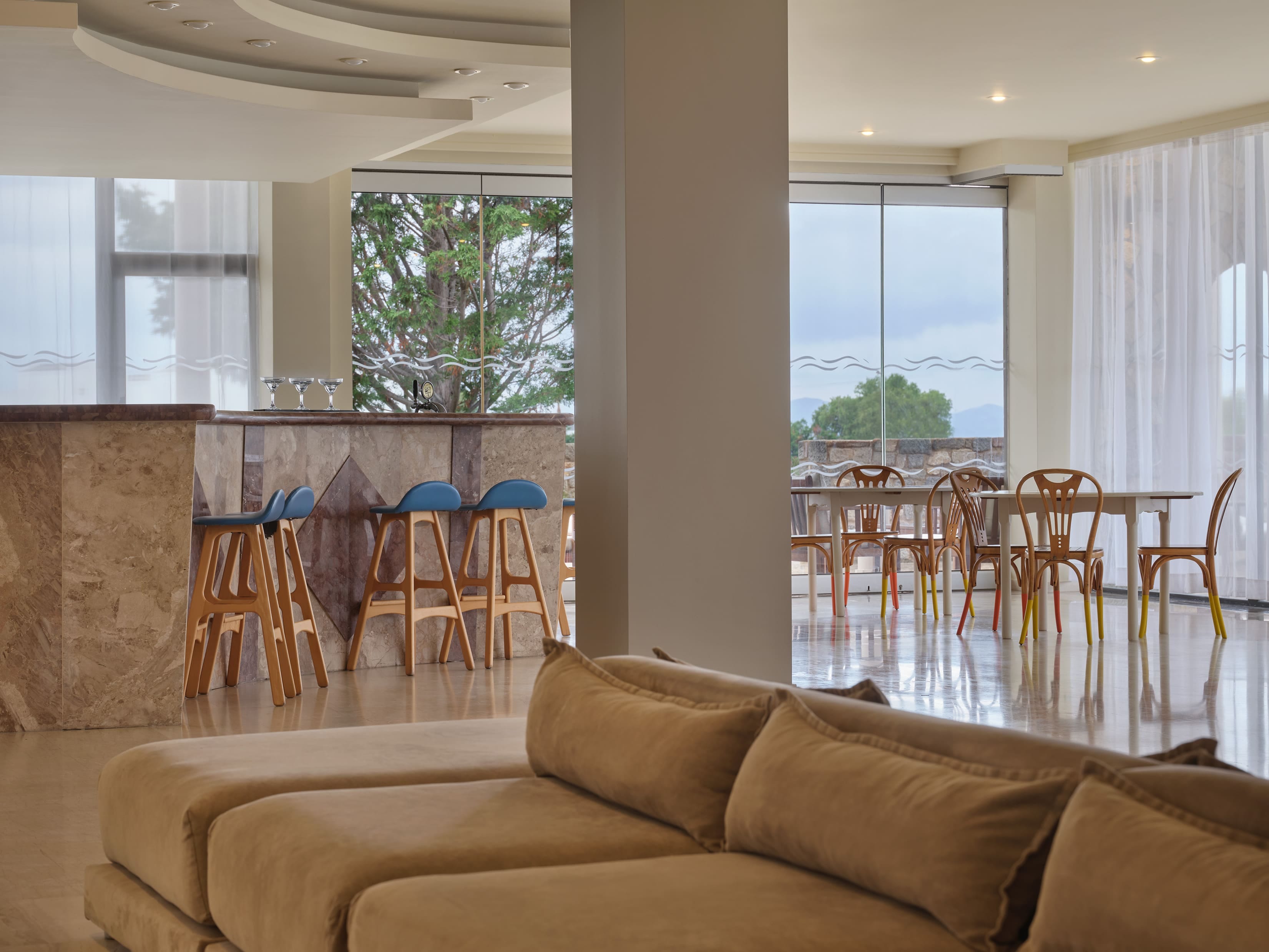 a room with a couch and chairs