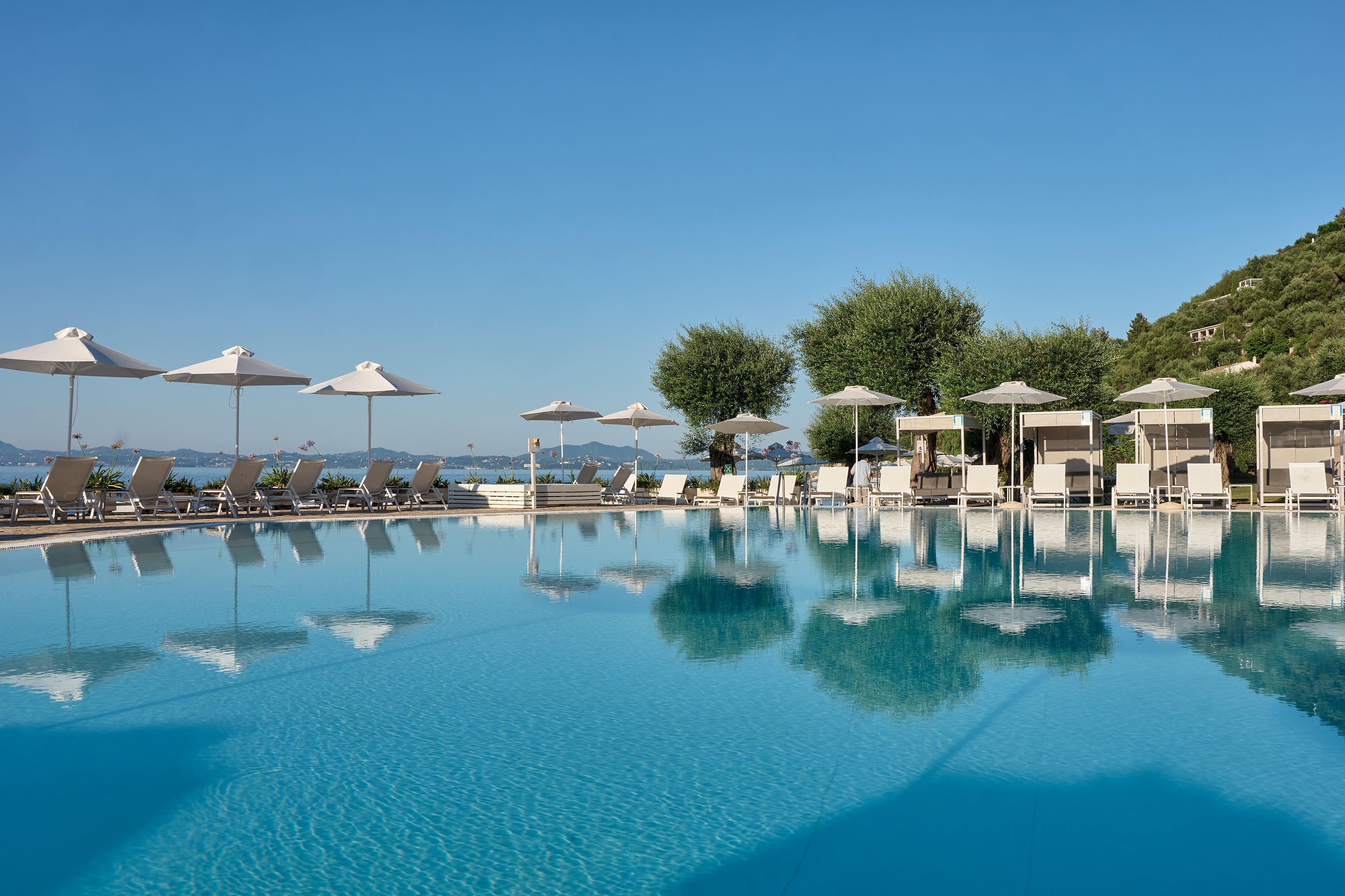 a pool with umbrellas and chairs