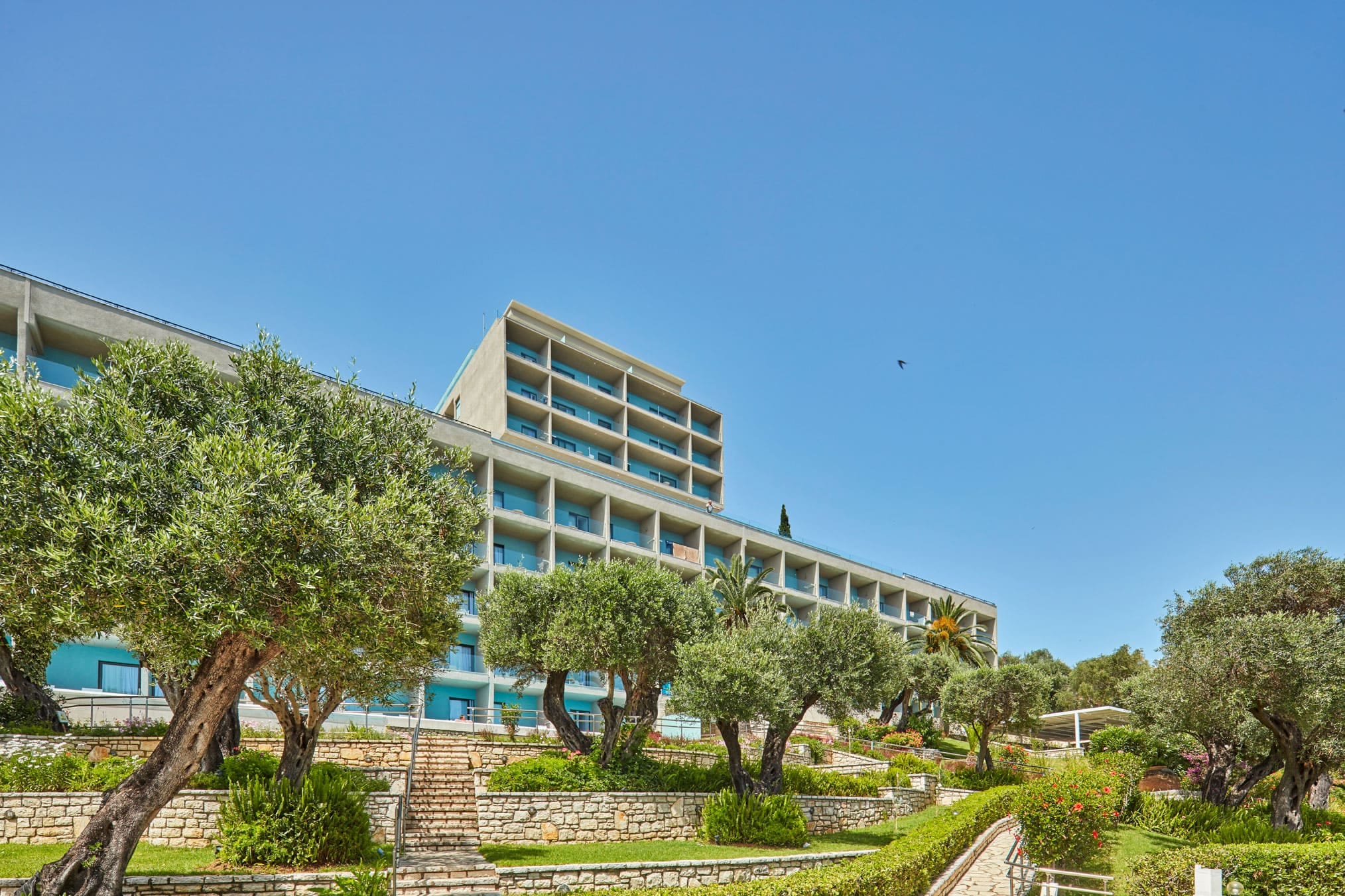 a building with trees and grass