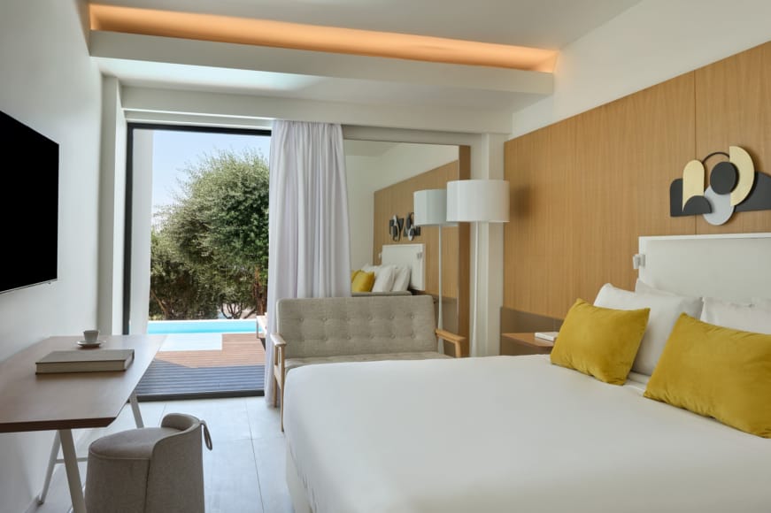 a bedroom with a bed and a tv