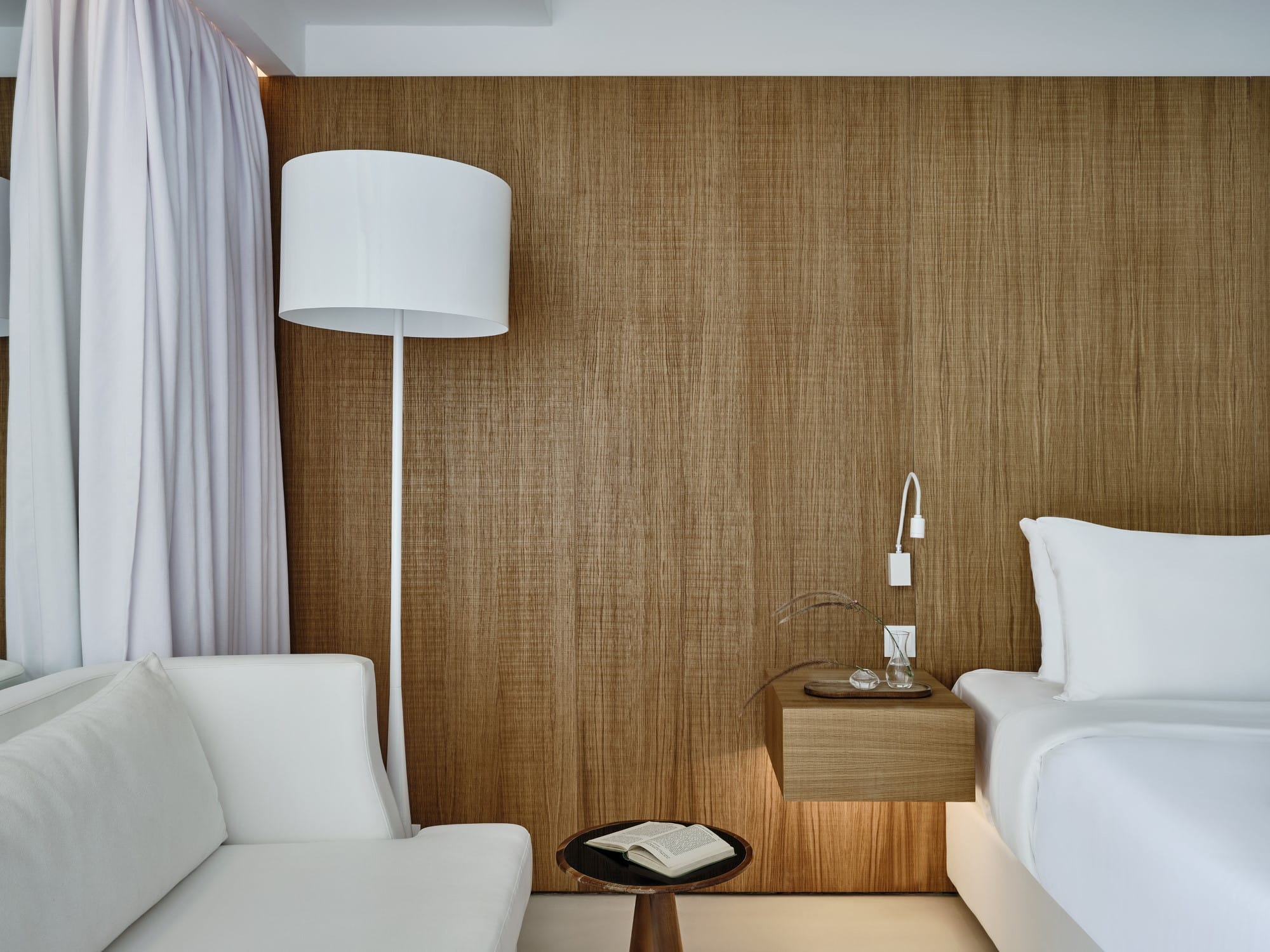 a room with a bed and a lamp